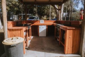 an outdoor kitchen with wooden counters and a counter top at Tiny Homes Escape at Grampians Edge by Tiny Away in Dadswells Bridge