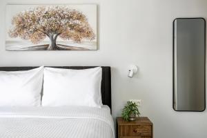 a bedroom with a bed with a tree picture on the wall at B48 Athens Dafni in Athens