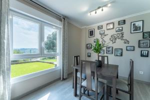 a dining room with a table and a large window at Casa San Martin in Cortiguera