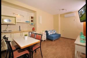 a kitchen and living room with a table and a couch at מול כנרת בליבנים in Livnim