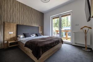 Ένα ή περισσότερα κρεβάτια σε δωμάτιο στο ff apartments Jasná Lúčky