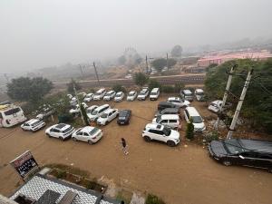 a bunch of cars parked in a parking lot at Hotel Lala Ji in Nīthrāna