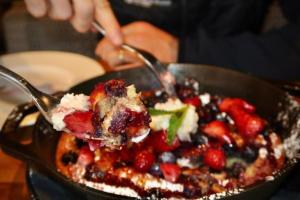 a bowl of food with berries and ice cream at Luxury 1 Bedroom At The Hythe In Lionshead Village in Vail