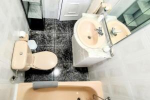 a bathroom with a toilet and a sink at Terrazas del Sur in Los Abrigos +60 photos