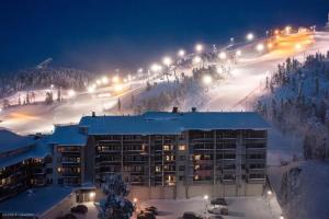 a hotel on a snow covered ski slope at night at Ruka Ski Chalets, Ski-In Ski-Out in Ruka