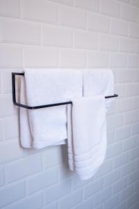 a group of towels hanging on a towel rack in a bathroom at Hôtel d'Angleterre, Salon-de-Provence in Salon-de-Provence +171 photos