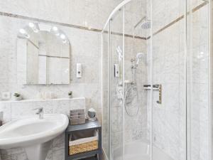 a white bathroom with a shower and a sink at Villa Rose Neu renoviert und voll ausgestattet in Königsberg in Bayern +13 photos
