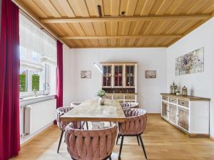 a dining room with a wooden ceiling and a table and chairs at Villa Rose Neu renoviert und voll ausgestattet in Königsberg in Bayern