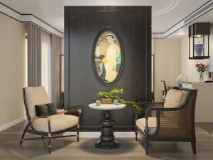 a living room with two chairs and a table at Soc Village Wellness & Retreat in Sóc Sơn