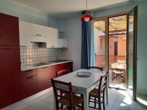 a kitchen with a table and chairs and a table and a table and a kitchen at Pergola n.3 in Cavo