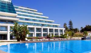 a large hotel with a swimming pool in front of a building at Hotel Cascais Miragem Health & Spa in Cascais +36 photos