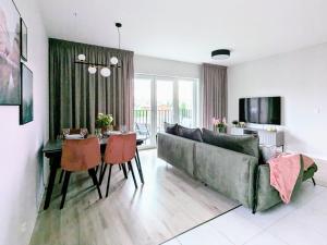 a living room with a couch and a table at Luxury in City -14- Stylish Free Parking in Łódź