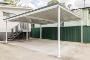 awning over a parking lot in front of a building at Smart Suites Self Check-in Apartments - S Freney in Brisbane