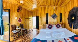 a bedroom with a bed in a wooden room at Dinh Sapa Trekking & Homestay in Lao Cai