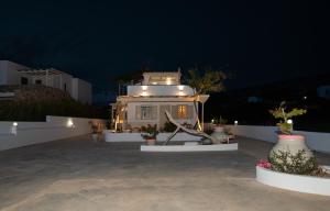 a small house with lights on it at night at Moustakas Beach Apartments in Adamantas