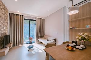 a living room with a table and a dining room at Soc Village Wellness & Retreat in Sóc Sơn