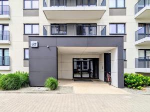 an apartment building with a door and a courtyard at Luxury in City -14- Stylish Free Parking in Łódź