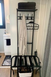 a black shelf with a towel hanging on it at Highway to Hobbiton Guesthouse - Matamata Central Location in Matamata