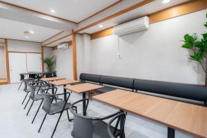 a row of tables and chairs in a room at Casa G,S, - Vacation STAY 53492v in Osaka