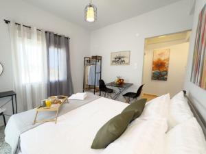 a bedroom with a bed and a table and chairs at Blue Hotel Apartments in Ierissos
