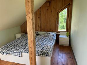 a bedroom with a bunk bed in a house at Denderi in Vaidava