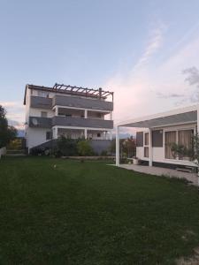 a building with a grass yard in front of it at Ante Noa in Ljubač