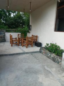 two wooden benches sitting on a patio at ბიჭვნარის სახლი in Itʼkhvisi