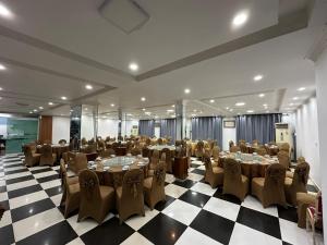 a banquet hall with tables and chairs in a room at Mekong Hotel in Ban Nabông