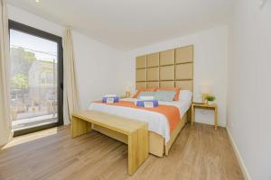 a bedroom with a bed and a large window at Villa Jade I in Can Picafort