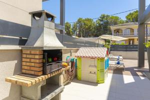 a toy oven and a toy house on a patio at Villa Jade I in Can Picafort