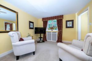a living room with two chairs and a television at The Brownlow Arms Inn in Grantham