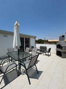 a patio with a table and chairs and a grill at Le Terrazze della dolce casa - Blue Sky - Casa Vacanze a Marina di Ragusa in Marina di Ragusa +69 photos
