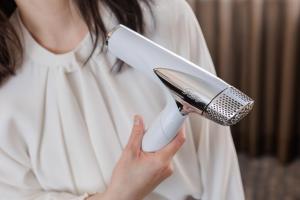a woman holding a microphone in her hand at HOTEL MYSTAYS PREMIER Kanazawa in Kanazawa