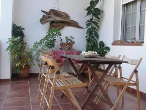 a table and chairs in a room with plants at El balcón de Alange in Alange +30 photos