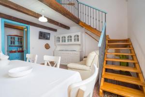 a room with a table and chairs and a staircase at Alghero Bastioni colombo sea view in Alghero