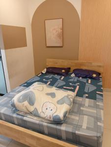 a bedroom with a bed with a blanket on it at Youth City Residence, Studio MUJI theme in Nilai