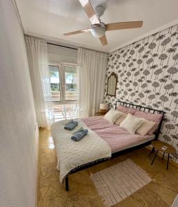 a bedroom with a bed with a ceiling fan at Apartament z widokiem na morze Cabo Roig in Orihuela Costa +20 photos