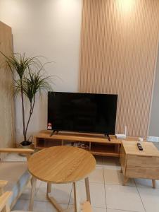 a living room with a flat screen tv on a table at Youth City Residence, Studio MUJI theme in Nilai
