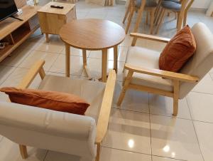 a group of chairs and a table in a room at Youth City Residence, Studio MUJI theme in Nilai