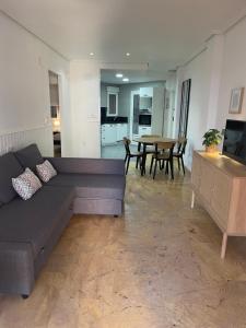 a living room with a couch and a table at Apartament z widokiem na morze Cabo Roig in Orihuela Costa