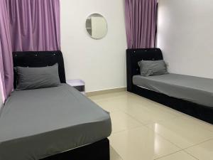 a room with two beds with purple curtains and a mirror at Hyve Soho suite in Cyberjaya