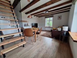 a dining room and living room with a table and chairs at Apartamenty Kukinia33 in Kukinia