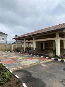 an empty parking lot in front of a building at Folulakes Regal Villas in Ibadan