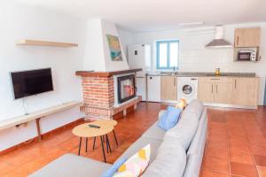 a living room with a couch and a fireplace at Casa Pedroso in Noja