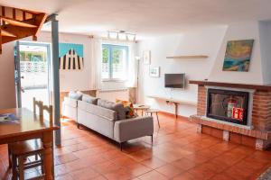 a living room with a couch and a fireplace at Casa Pedroso in Noja