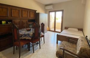 a room with a table and a bed and a dining room at Aphrodites Gardens in Ormos Panagias +7 photos