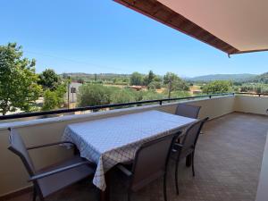a table and chairs on a balcony with a view at Aphrodites Gardens in Ormos Panagias
