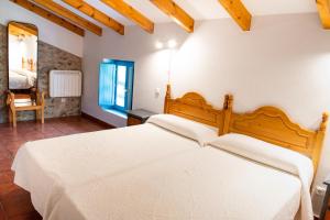 a bedroom with a large white bed in a room at Casa Pedroso in Noja