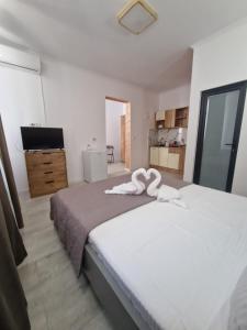 En eller flere senge i et værelse på Casa Carina