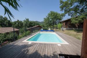 einen Pool auf der Terrasse eines Hauses in der Unterkunft Chalet Orange - Piscine Partagée in Darbres